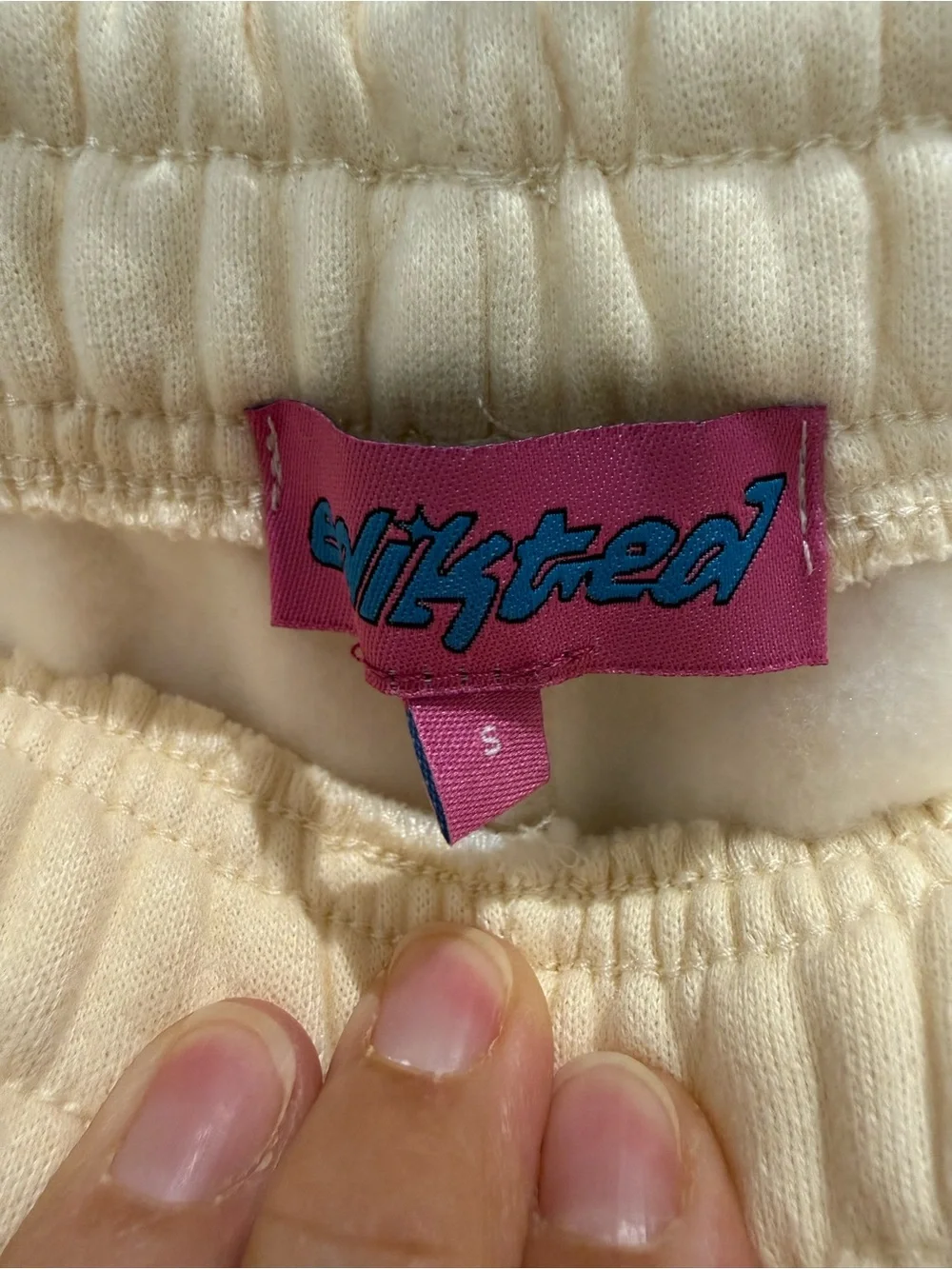 Edikted Cream/Light YellowTrack Pants with Pink Bow Detail on back of pants.